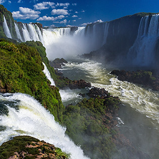Tourists enjoy a boat ride below the Iguazu Falls