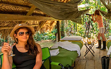 Woman enjoys a drink at a jungle safari in Ecuador