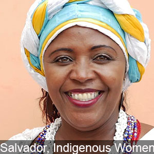 An Indigenous woman in Salvador smiles for the camera